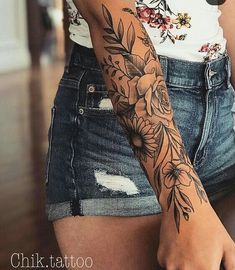 a woman with a flower tattoo on her arm