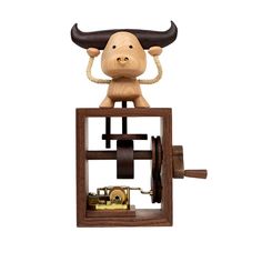 a wooden clock with a cow on top of it