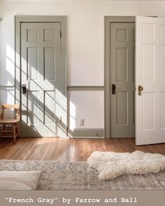 a room with two doors and a rug on the floor