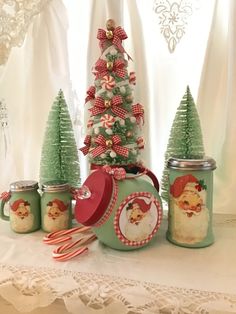 a table topped with jars filled with christmas decorations