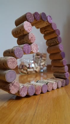 several wine corks are arranged in the shape of a arch on a wooden floor