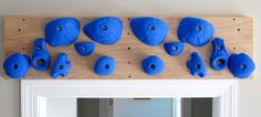 several blue plastic objects are arranged on a wooden surface with holes in the middle and bottom