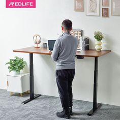 a man standing in front of a computer desk