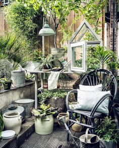 an outdoor patio with potted plants and chairs