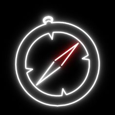 a neon sign with a compass on it in the middle of a black background that is lit up