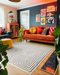 a living room filled with furniture and plants