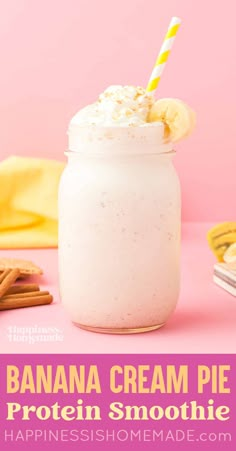 a banana cream pie protein smoothie in a mason jar with a yellow and white striped straw