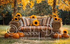 a couch with sunflowers on it and hay bales