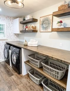 a washer and dryer in a room with wood flooring on the walls