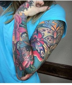 a woman with colorful tattoos on her arm