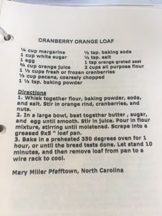 the recipe for cranberry orange loaf cake is shown on top of an open book