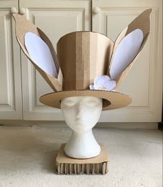 a paper hat with ears on top of a mannequin head