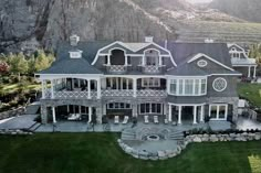 this is an aerial view of a large house in the mountains with lots of windows and balconies