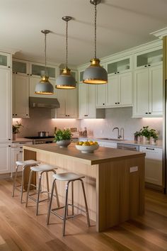 a kitchen with an island and stools in it