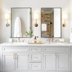 a bathroom with double sinks and two mirrors on the wall next to eachother