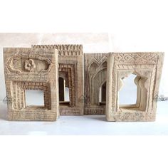 three carved wooden frames sitting next to each other