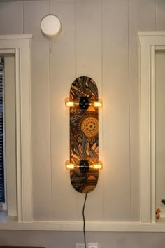 a skateboard mounted to the side of a wall with lights on it's sides