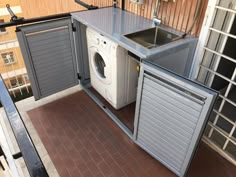 a washer and dryer sitting on top of a balcony