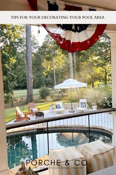 an american flag hanging from the side of a house next to a pool with chairs and umbrellas