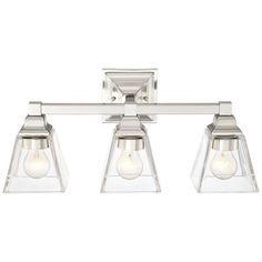 three light bathroom fixture in chrome finish with clear glass shades on the top and bottom