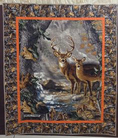 two deer standing next to each other in front of a forest scene with leaves and flowers