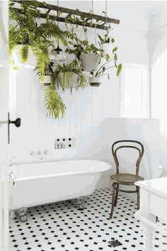 a white bath tub sitting next to a wooden chair