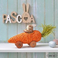 a wooden sign that says pasqua with a small bird sitting on top of it