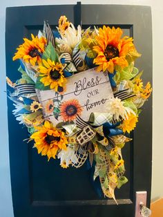 a sunflower wreath with the words, blessing and our home written on it's front door