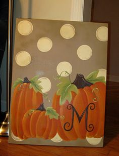 a painting of pumpkins with the letter m on it