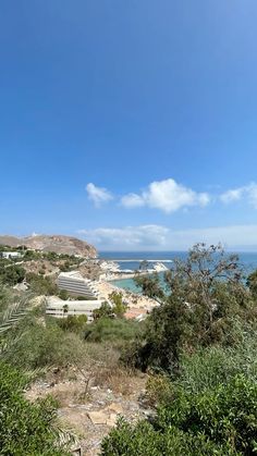 a view of the ocean from an overlook point on a sunny day with blue skies