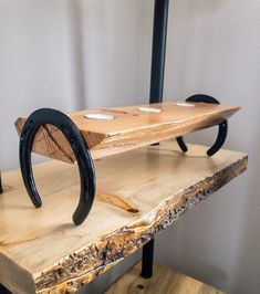 a piece of wood that has some sort of object on it, sitting on top of a table