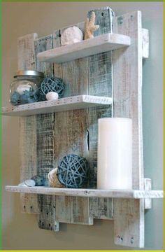 two wooden shelves with candles and other items on top of them, one shelf is made out of pallet wood