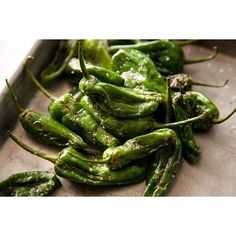 green peppers sitting on top of a metal tray