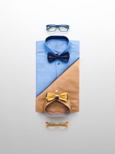 a blue shirt and yellow bow tie with glasses on the side, next to a pair of eyeglasses