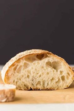 a piece of bread sitting on top of a wooden cutting board