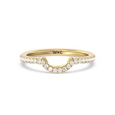 a yellow gold wedding band with diamonds on the bottom and an arrow design in the middle