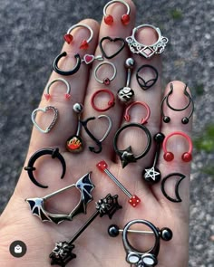 a person is holding many different rings in their hand and there are other items on the palm