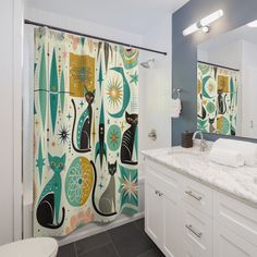 a bathroom with a shower curtain decorated with cats