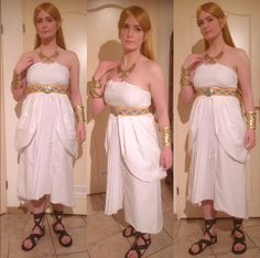 a woman in white dress standing next to a door wearing gold bracelets and sandals