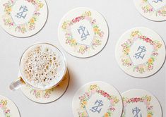 a cup of coffee sitting on top of a saucer next to some coasters