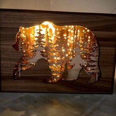 the bear is made out of wood and has lights on it's back side