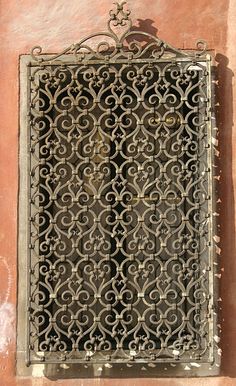 an iron grate on the side of a building