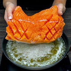 someone is cooking salmon in a skillet on the stove