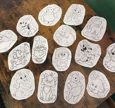 many cartoon characters are on the table with some paper cut out to look like them