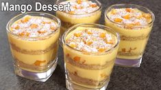 four desserts are arranged in small glasses on a table with the words mango dessert above them