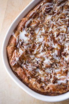 a casserole dish with nuts and cream on top