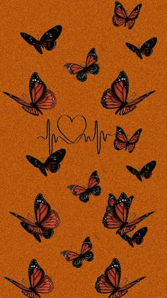 many butterflies are flying in the air with a heart on it's back ground