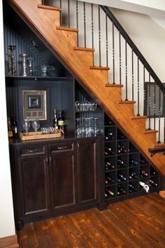 the wine rack under the stairs is full of bottles