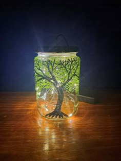 a glass jar with a tree in it