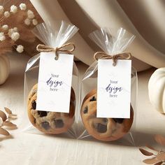 two cookies wrapped in cellophane and tied with twine are sitting on a table